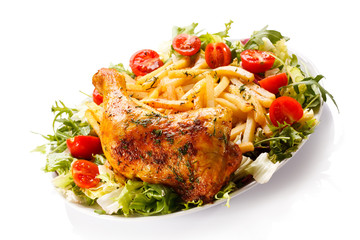 Grilled chicken leg with chips and vegetables