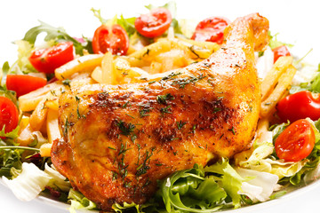 Grilled chicken leg with chips and vegetables