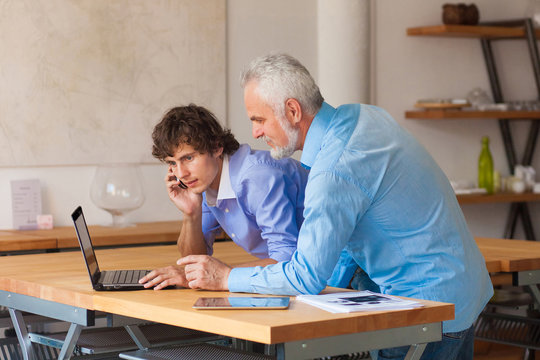 business man working on laptop with Colleges indoor