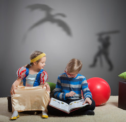 Brother reads tale about knight and dragon to little sister