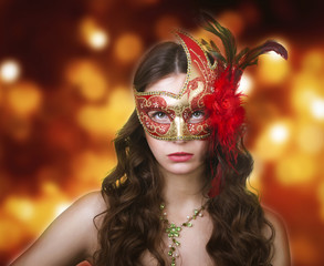 Naklejka premium Woman in masquerade mask on a festive background.