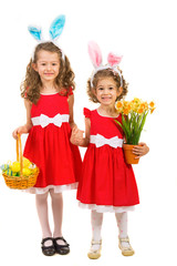 Fototapeta premium Happy sisters with bunny ears and easter eggs