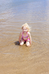 little girl on the beach at sea