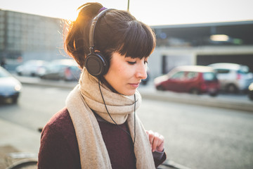 young beautiful hipster woman listening music