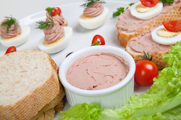 plate with slices of bread with home made pate,with vegetables