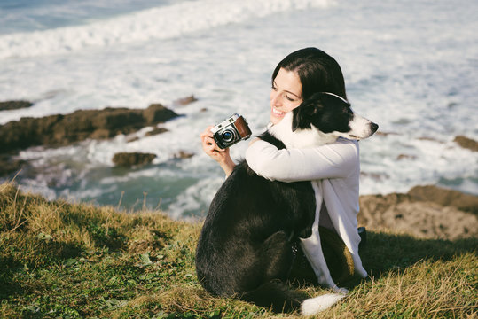 Woman hugging dog on vacation travel