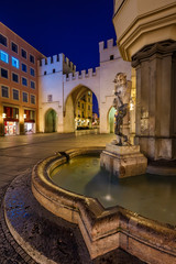 Brunnenbuberl Fountain and Karlstor Gate in the Evening, Munich,