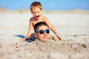 family having fun on the beach