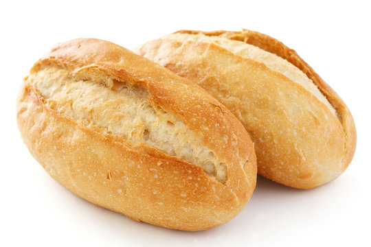 Two crusty mini baguettes on white surface