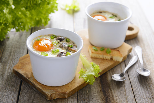 Baked eggs with mushrooms, cream and chives - healthy breakfast