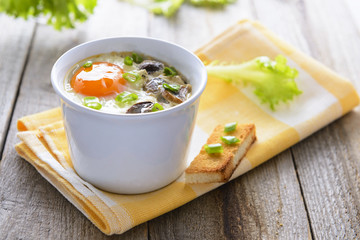 Baked egg with mashrooms and toast