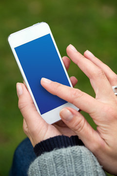woman's hand using smartphone with finger