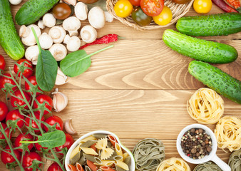 Fototapeta na wymiar Fresh ingredients for cooking: pasta, tomato, cucumber, mushroom