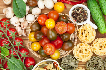 Fresh ingredients for cooking: pasta, tomato, cucumber, mushroom