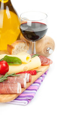 Red wine with cheese, prosciutto, bread, vegetables and spices