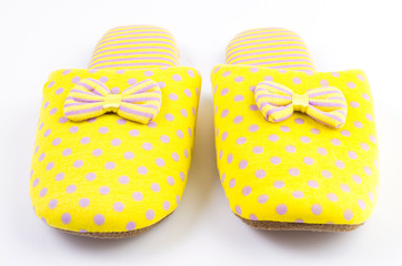 Yellow house slippers isolated on white background