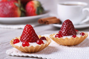 two tartlets with strawberries, cranberries and cream