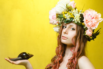 calm pretty girl with snail and flower crown on head