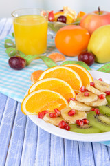 Sweet fresh fruits on plate on table close-up