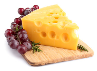 Piece of cheese and grape on wooden board, isolated on white