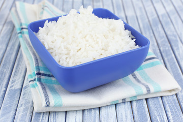 Cooked rice in bowl on wooden background