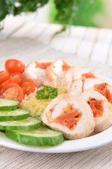 Delicious chicken roll on plate on table close-up