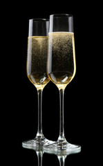 Glasses of champagne, on black background