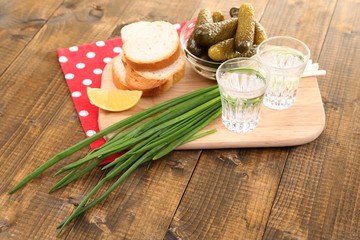 Composition with glasses of vodka and marinated  cucumbers