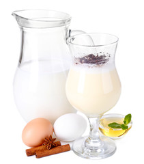 Eggnog with milk and eggs isolated on white