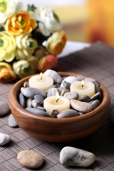 Composition with spa stones, candles  and flowers