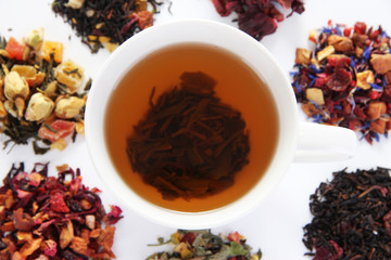 Cup of tea with dry tea isolated on white