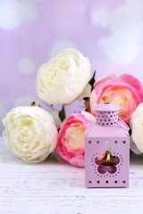 Decorative metallic lantern and artificial flowers