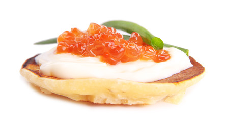 Pancake with red caviar isolated on white