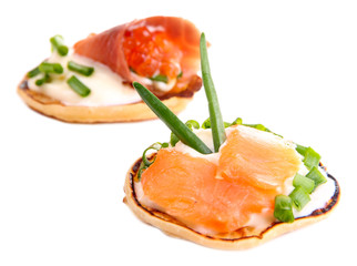 Pancakes with red caviar and salmon,  isolated on white