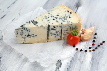 Tasty blue cheese on old wooden table