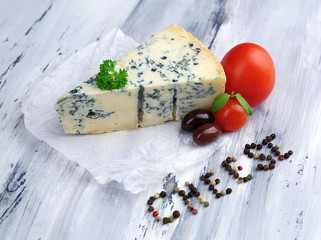 Tasty blue cheese on old wooden table