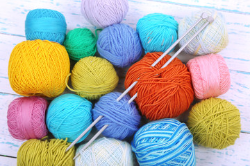 Yarns for knitting on wooden table close-up