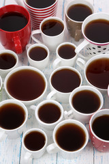 Many cups of tea on table close-up