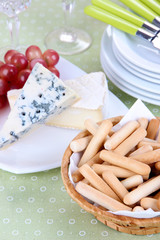 Composition with cheese, grape and bread sticks