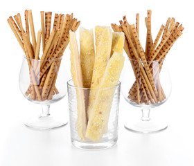 Bread sticks in glasses isolated on white