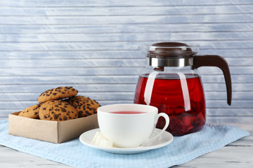 Jar of herbal tea and cookies on table