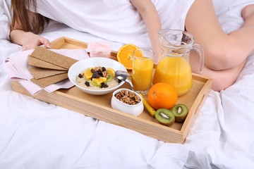 Woman in bed with light breakfast