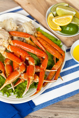 Crab legs with fresh lemon slices and butter sauce