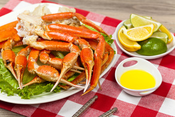 Snow Crab legs with fresh lemon slices and butter sauce