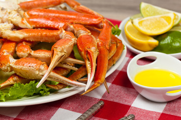 Snow Crab legs with fresh lemon slices and butter sauce