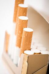 Tobacco in cigarettes with a brown filter close up © Valeri Luzina