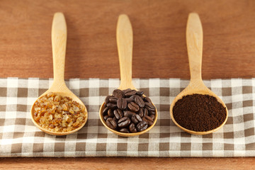 coffee beans and sugar in wooden spoon