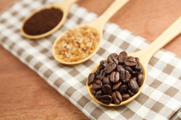 coffee beans and sugar in wooden spoon