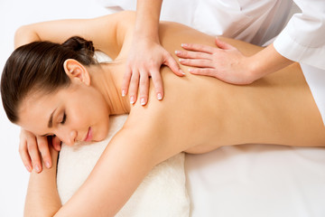 Fototapeta na wymiar Masseur doing massage on the back of woman in the spa salon.