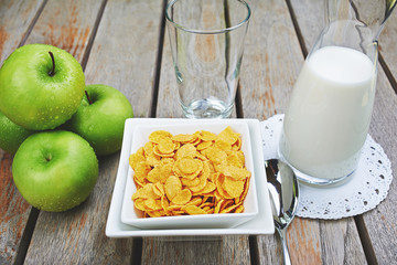 corn cereal with fresh milk and green apples